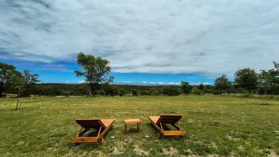 two picnic tables in a field of grass at Mutterstern Chalet Boutique in Villa General Belgrano