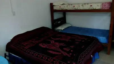 a small bedroom with a bunk bed with a blanket at Fernando in Villa Independencia