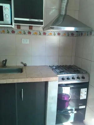 a kitchen with a stove and a counter top at Fernando in Villa Independencia