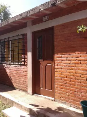 a red brick building with a brown door at Fernando in Villa Independencia