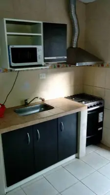a small kitchen with a sink and a stove at Fernando in Villa Independencia