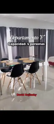 a dining table and chairs in a room at Departamento en Veneto 4 u 8 in Villa Carlos Paz