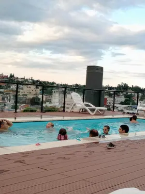 a group of people in a swimming pool at Departamento en Veneto 4 u 8 in Villa Carlos Paz
