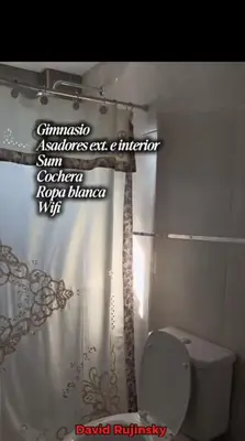 a bathroom with a toilet and a shower curtain at Departamento en Veneto 4 u 8 in Villa Carlos Paz