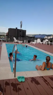 a group of people in a swimming pool at Departamento en Veneto 4 u 8 in Villa Carlos Paz