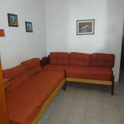 a brown couch in a room with at Colores de Traslasierra in Mina Clavero