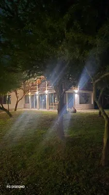 a building with a tree in front of it at Ilusión tunkelen in Merlo
