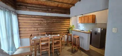 a dining room with a table and a refrigerator at Ilusión tunkelen in Merlo