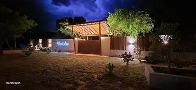 a building with a pavilion in a yard at night at Ilusión tunkelen in Merlo