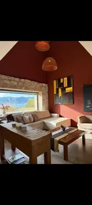 a living room with a couch and a table at Villa Lourdes in La Estancia