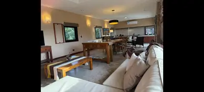 a living room with a couch and a table at Villa Lourdes in La Estancia