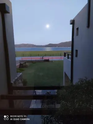 a view from a window of a yard with a view of the water at Villa Lourdes in La Estancia