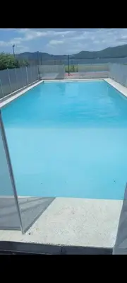 a large swimming pool with blue water at Villa Lourdes in La Estancia