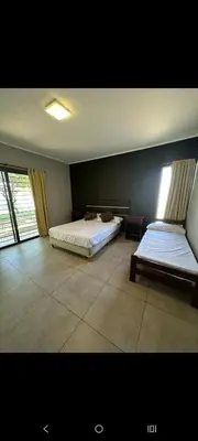 a bedroom with two beds in a room at Sueños Del Valle in Villa Anizacate