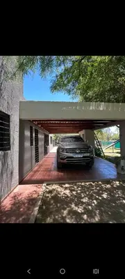 a car is parked under a car garage at Sueños Del Valle in Villa Anizacate