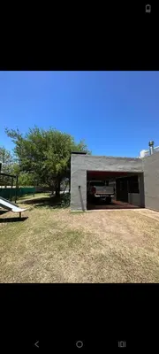 a building with a truck parked in a yard at Sueños Del Valle in Villa Anizacate