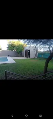 two pictures of a house and a yard with a pool at Sueños Del Valle in Villa Anizacate