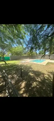 a park with a fence and a swimming pool at Sueños Del Valle in Villa Anizacate