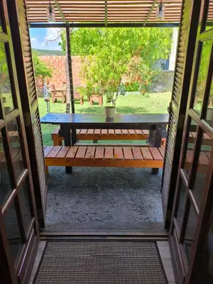 a view of a table and bench through a door at Tu Escapada in Santa María