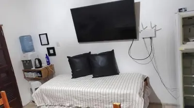 a bedroom with a bed with a flat screen tv on the wall at Tu Escapada in Santa María