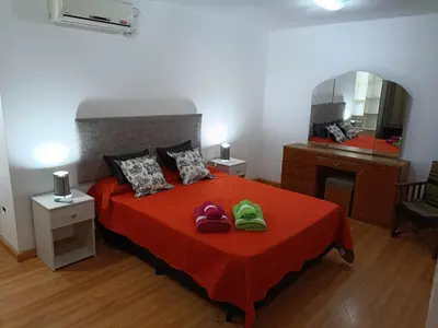 a bedroom with a bed with two pairs of shoes on it at Deptos Charito in Cordoba