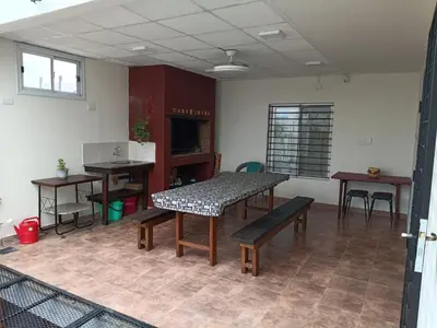 a room with a table and benches in a room at Deptos Charito in Cordoba