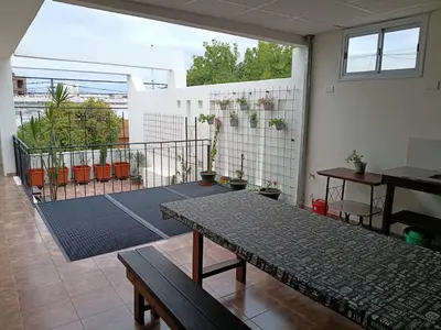 a living room with a table and a balcony at Deptos Charito in Cordoba
