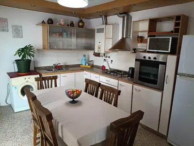 a kitchen with a table with a bowl of fruit on it at Deptos Charito in Cordoba
