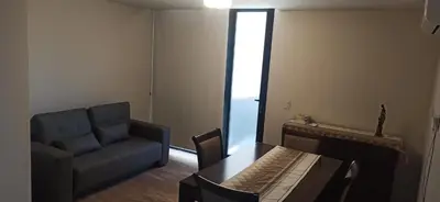 a living room with a couch and a table and a chair at Hermoso Departamento en Opera Plaza al lado de Quality Espacios in Cordoba