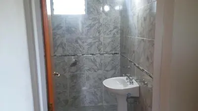 a bathroom with a toilet and a sink and a shower at Departamentos Paz Serrana in Villa Cura Brochero