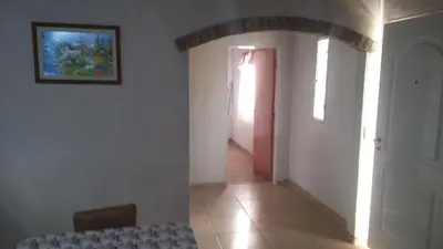a room with a hallway with a table and a door at Departamentos Paz Serrana in Villa Cura Brochero