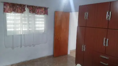a bedroom with wooden cabinets and a window at Departamentos Paz Serrana in Villa Cura Brochero