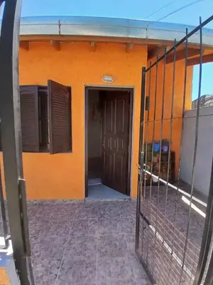 a orange building with a gate in front of it at Apart La Jose in Río Cuarto