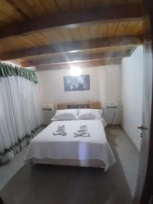 a bedroom with a bed with two towels on it at Apart La Jose in Río Cuarto