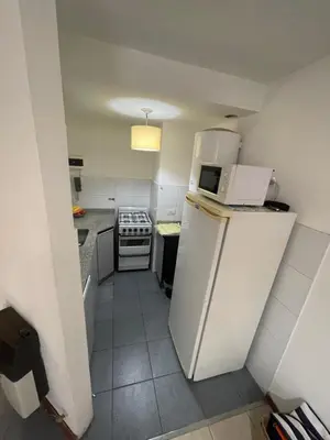 a small kitchen with a refrigerator and a stove at Nueva Córdoba in Cordoba