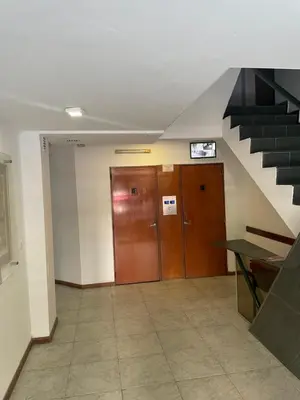 an office hallway with a staircase and a brown door at Nueva Córdoba in Cordoba