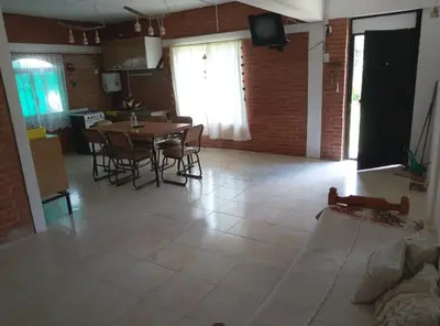 a kitchen and dining room with a table and chairs at María Reina De La Paz in Villa Cura Brochero