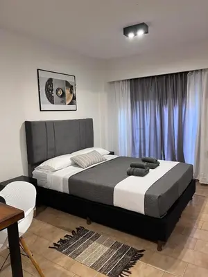 a bedroom with a large bed in front of a window at Monoambiente moderno en Nueva Córdoba Gray Urban in Cordoba