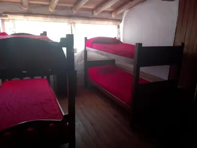 a room with two bunk beds and a window at Departamento mina clavero in Mina Clavero