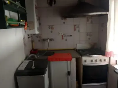 a small kitchen with a stove and a sink at Departamento mina clavero in Mina Clavero