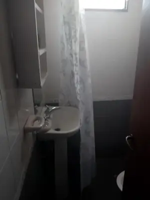 a bathroom with a sink and a shower curtain at Departamento mina clavero in Mina Clavero