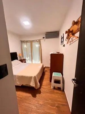 a bedroom with a bed and a step stool at Las Catitas in Villa Carlos Paz