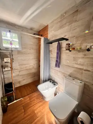 a bathroom with a toilet and a sink at Las Catitas in Villa Carlos Paz