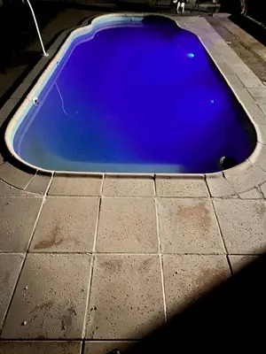 a blue swimming pool sitting on a tile floor at Las Catitas in Villa Carlos Paz