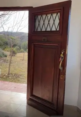 a wooden door with a view of a field at Villa Pellegrini in Trapiche