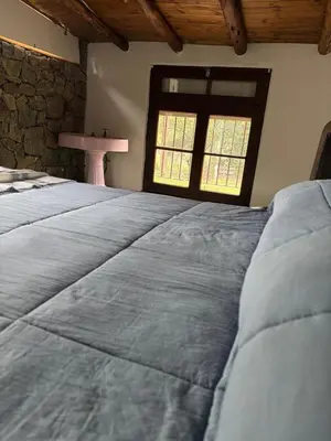 a large bed in a room with a window at Villa Pellegrini in Trapiche