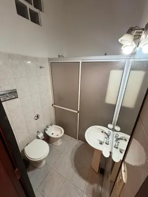 a bathroom with a toilet and a sink at La casa del Sapo Pepe Carlos Paz in Cordoba