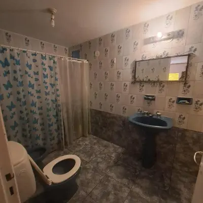 a bathroom with a toilet and a sink at La Tia in Alta Gracia