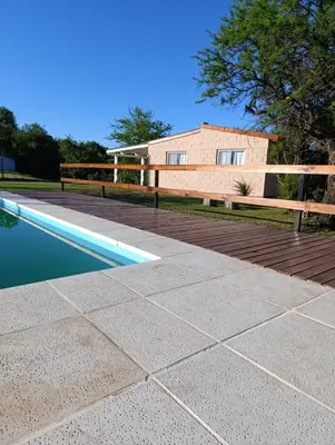 a patio with a swimming pool and a house at Cabañas EL VALLE in San Ignacio