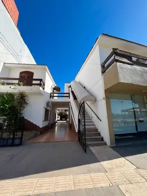 a white building with a staircase in front of it at Departamento espiral in Embalse
